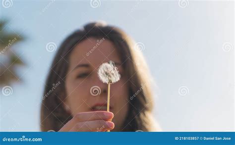 Blonde Girl Blowing On Dandelions Spring Holidays And Mood Stock Image