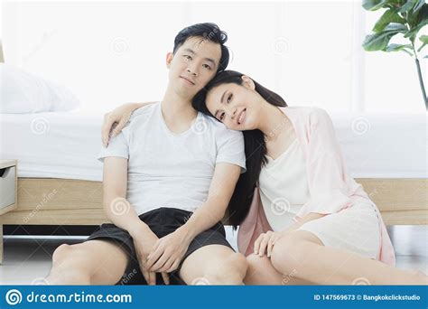 Couple In Pajamas Sit On Floor In Bedroom Stock Image Image Of Model