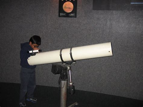 Checking Out A Display Refracting Telescope Inside The Wetherbee