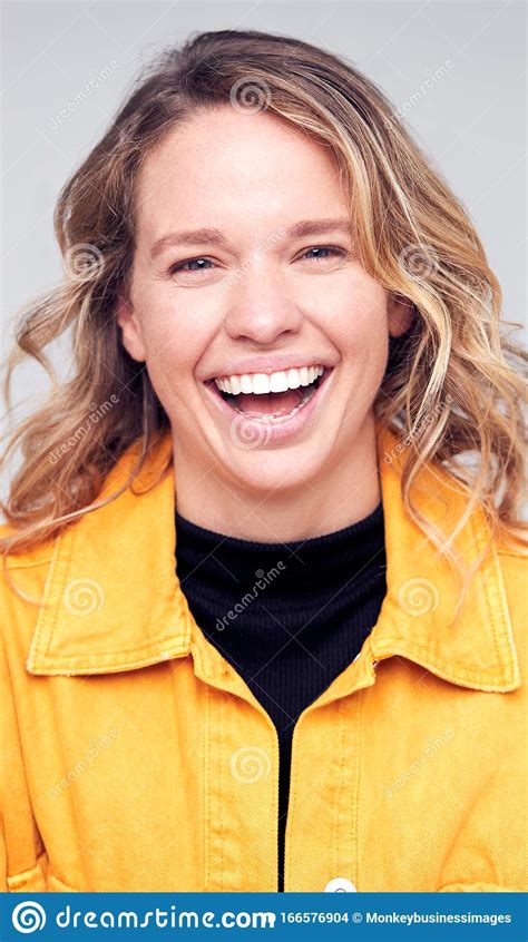 Studio Portrait Of Positive Happy Young Woman Smiling At Camera Stock