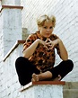 Tuesday Weld posing on a wall, 1963. – Bygonely