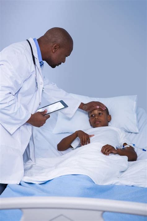 Male Doctor Checking Patient Fever During Visit In Ward Stock Image Image Of Clinical