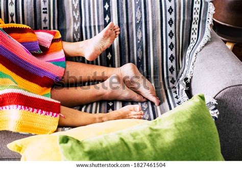 Couple Having Sex Activity Concept With Nude Feet And Coloured Cover On The Sofa At Home