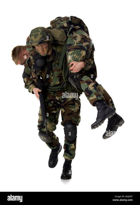 Soldier Carrying An Injured Soldier On His Shoulders Stock Photo