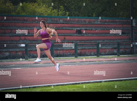 Girl Model Athlete Running On The Running Track Stock Photo Alamy