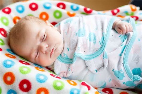 Cute Little Newborn Baby Girl Sleeping Wrapped In Blanket Stock Image