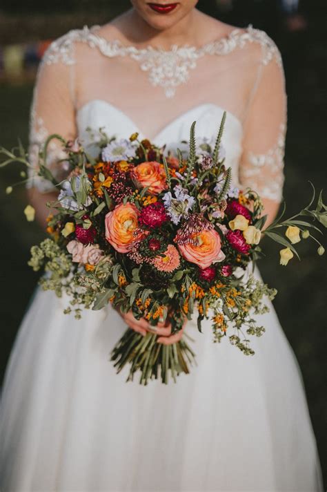 Fall wedding flowers consist of rich reds, dark oranges and vibrant yellows. Roses and wild flowers for an end of summer/early autumn ...