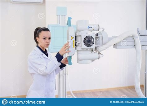 Lateral View Of A Woman Radiologist Adjusting The X Ray Machine Stock Photo Image Of