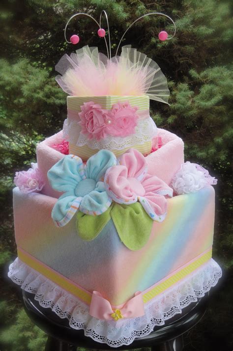 (3) white ribbon tied around the layers, (3) white 3in. Slanted Girl's Diaper Cake www.facebook.com ...
