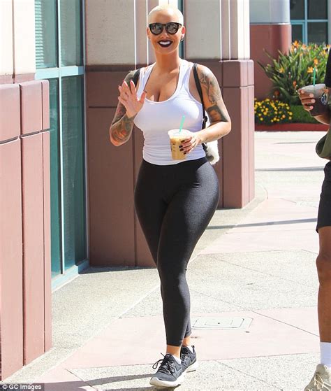 amber rose squeezes her curves into tight top and leggings as she grabs a coffee to go daily