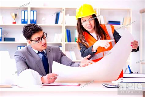 Construction Foreman Supervisor Reviewing Drawings Stock Photo