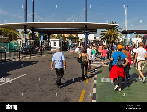Pedestrians Crossing The Border From Gibraltar Into Spain At La Linea