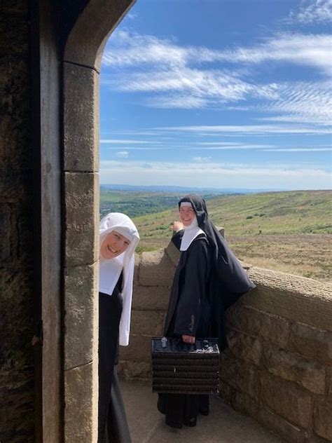 the sisters adorers climb darwen hill on a warm sunny day sisters adorers of the royal heart