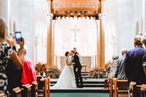 Bride And Groom First Kiss Indoor Church Catholic Wedding Ceremony In