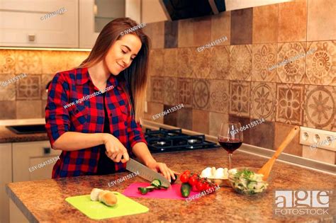 Portrait Of Smiling Young Housewife In Modern Kitchen Woman Cooking