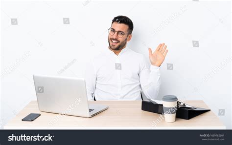 Young Businessman Workplace Saluting Hand Happy Stock Photo 1669182601