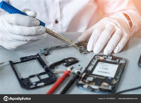 Asian Technician Repairing Smartphones Motherboard Soldering Magnifier