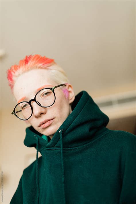 lesbian woman with short red and white hairs and glasses by stocksy contributor alexey kuzma