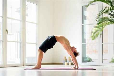 Premium Photo Man Practicing Yoga Doing Bridge Pose