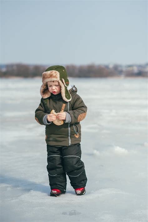 Boy Fishing On Winter Cute Boy Catches Fish In The Winter Lake Winter