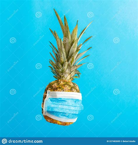 Pineapple In Medical Mask On Color Blue Background Pineapple Fruit In