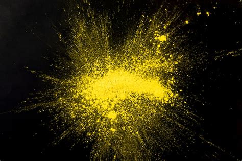 Free Photo Explosion Yellow Colored Powder On Black Surface