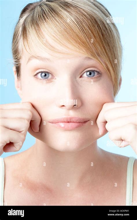 Close Up Of A Young Woman Pinching Her Cheeks Stock Photo Alamy