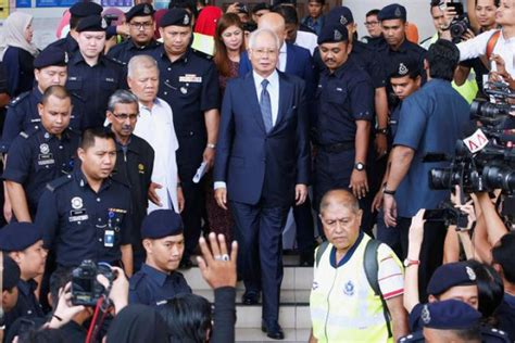 Online version of updated text of reprint. Malaysia issues arrest warrant for Najib's British aide