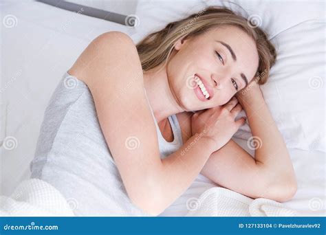 Portrait Of Beautiful Woman Awakening In Her White Bed And Yawningrestsleepingpeople And