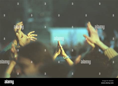 Hands Clapping And Waving In Crowd Watching Music Concert Stock Photo