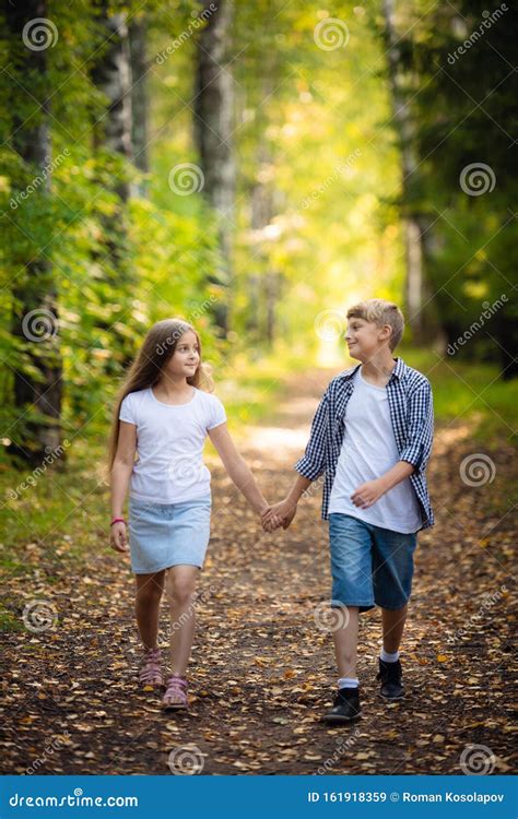 First Love Little Boy And Girl Holding Hands And Smiling While Walking