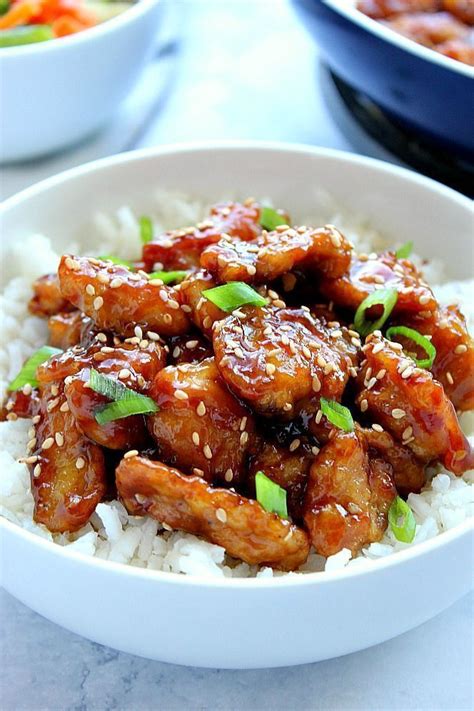 easy sesame chicken recipe battered chicken fried in a pan and coated with sesame sauce