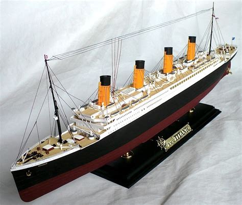 A Model Ship Is Shown On A White Background With Black And Gold Trimmings