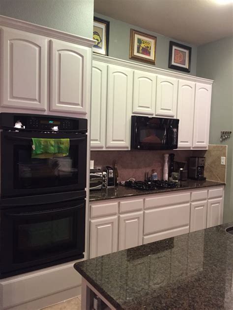 If your cabinets are painted… before embarking, remove one of the doors and sand off a small area of the finish on the back. After - painted oak kitchen cabinets using Fine Paints of ...