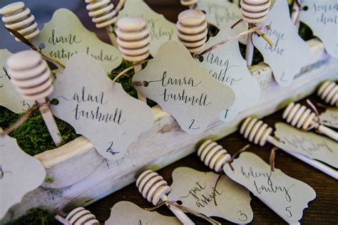 Small Wooden Pins With Names On Them Sitting Next To Each Other