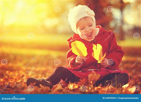 Happy Little Child Baby Girl Laughing And Playing In Autumn Stock