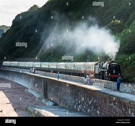 The Torbay Express Steam Train Moves Along The Brunel Coastal Line At