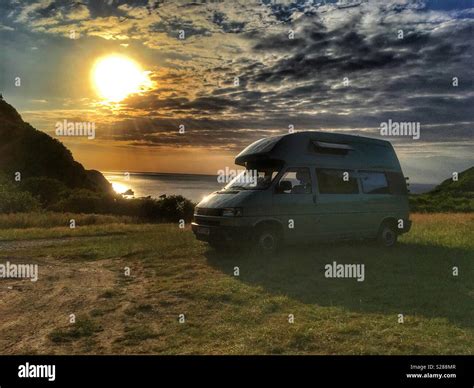 Vw Camper Van Parked By The Sea At Sunset In Lee Bay North Devon Exmoor