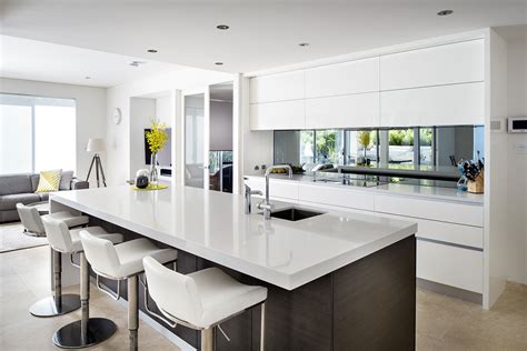 This is a small modern gallery kitchen which uses high gloss white laminates for its cabinets, combined with stainless steel appliances & hardware and white solid surface counter top for that ultra modern look. Modern Kitchen Design Cabinet High Gloss Kitchen Cabinet