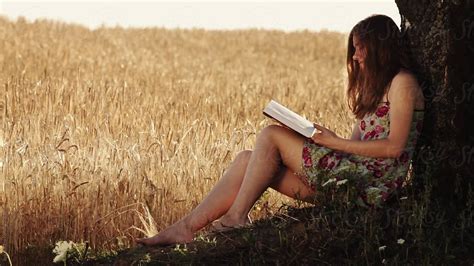 Woman Read Book Nature Wheat Field By Stocksy Contributor Ilya Stocksy