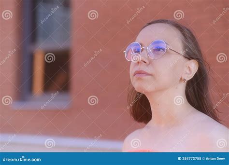 Portrait Of Young Woman With Short Hair In Glasses Looking Away