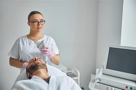Male Patient Receiving Laser Facial Treatment In Cosmetological Clinic