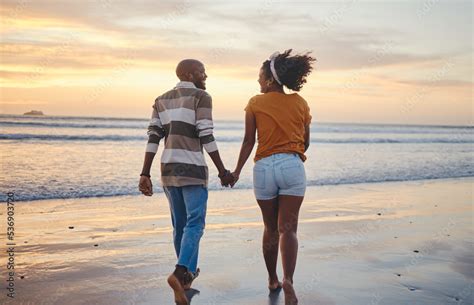 Black Couple Holding Hands And On Beach With Sunset For Romance Celebrate Relationship Or