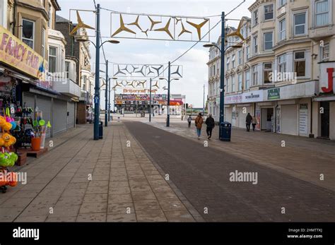 view of regent road great yarmouth in winter with small number of shops open and pedestrians