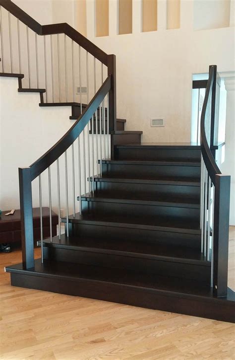 The dark color wood and bright chrome are professional and a timeless combination. Stainless Steel Handrails: Strength And Sophistication | Modern staircase, Modern stair railing ...
