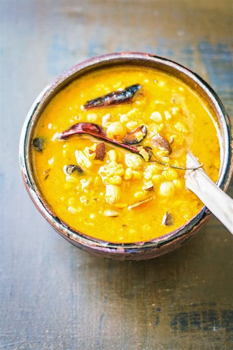 mix and stir bengali style cholar dal lentils with coconut and spices