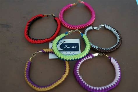 Several Different Colored Bracelets Are Sitting On A Table With A Name