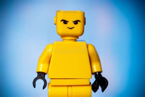 Yellow Lego Figure With An Evil Face On A Blue Background Editorial