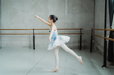 Ballerina practicing choreography in spacious studio · Free Stock Photo