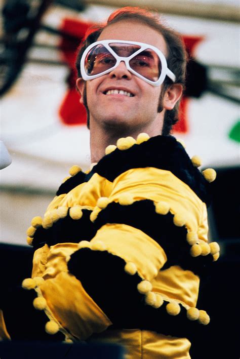 All of elton's early stage costumes were found in shops, from the white dungarees we see him wear at his in one memorable scene in rocketman, elton is seen in a multicoloured chicken outfit, replete with. Elton John Photos: The Rock & Style Icon Through the Years ...